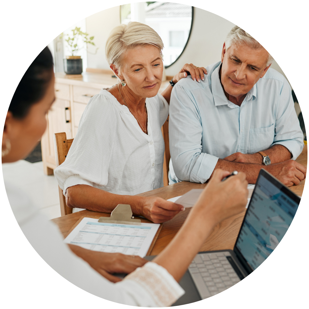 Exit Planning and Succession Strategies an older couple looking at paperwork with a financial advisor